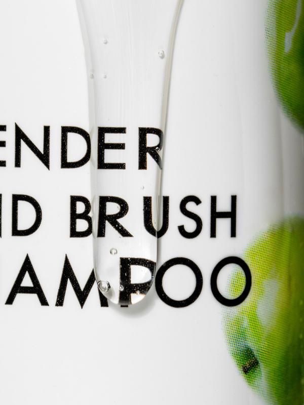 Shampoo bottle with text 'Lavender and Brush Shampoo' on a white background
