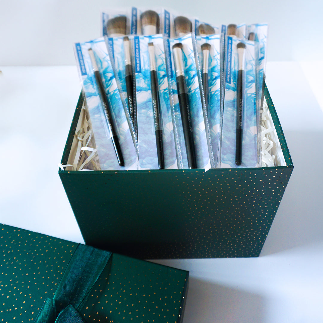 Set of Cinema Secrets makeup products in a green box on a white background