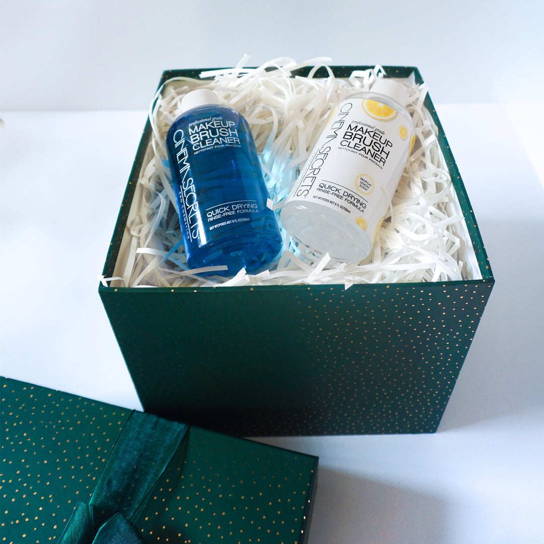 Two makeup brush cleaners in a green box with white interior