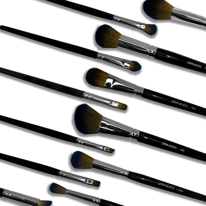 Multiple makeup brush laying flat on a white background