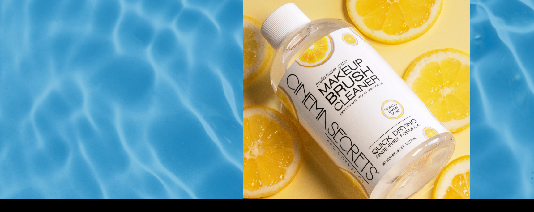 Makeup brush cleaner bottle with lemon slices on a blue water background