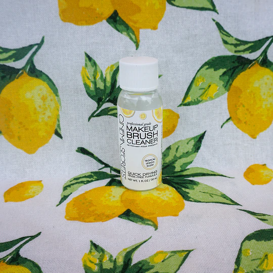 Mini brush cleaner bottle on a lemon table cloth