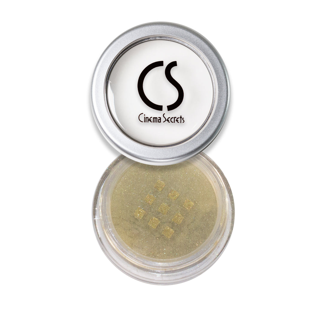 round container of gold eye shadow on white background