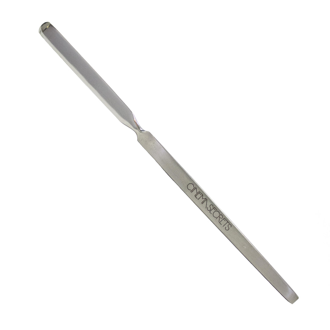 stainless steel makeup spatula on white background