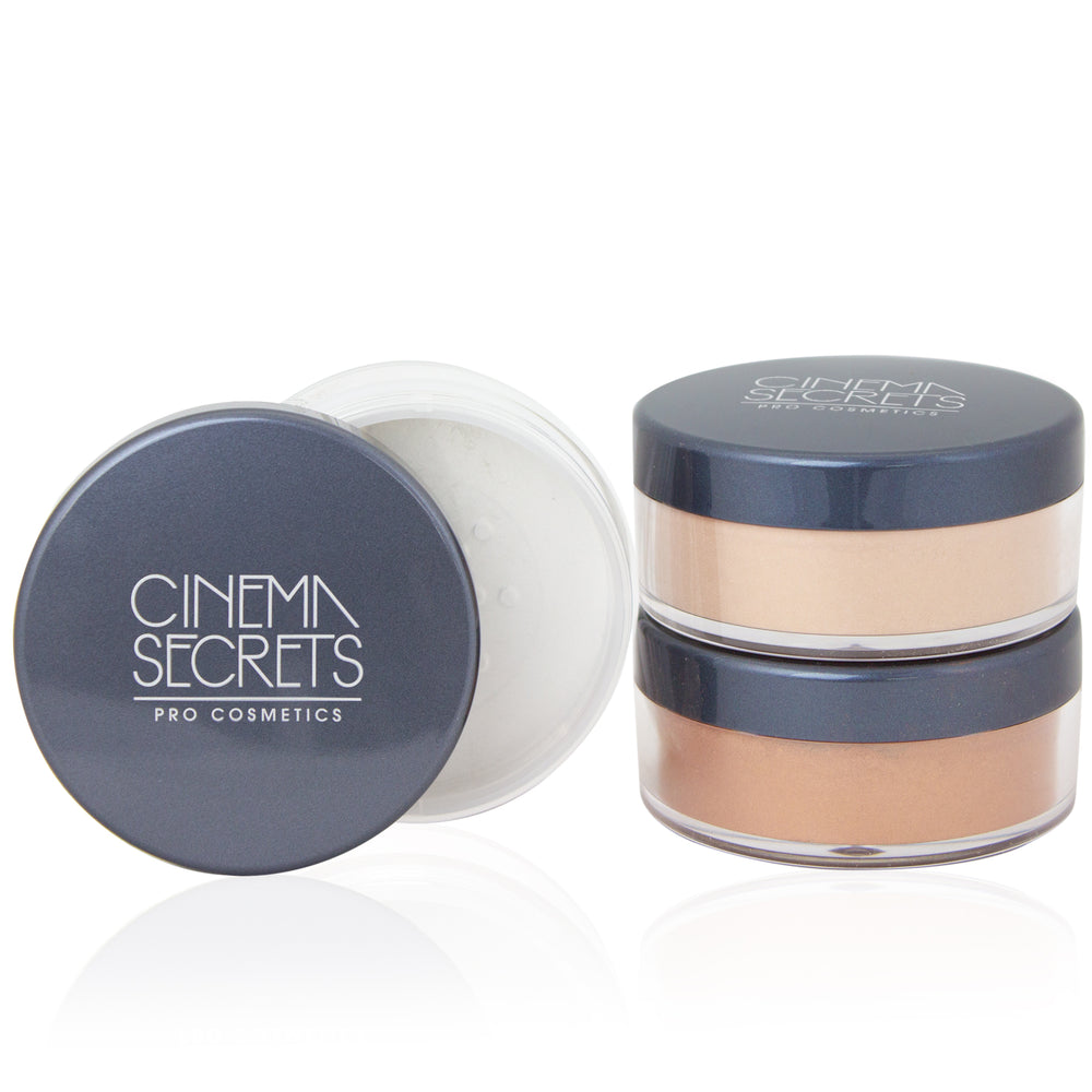 two stacked silver lid powder comapcts next to one open powder container